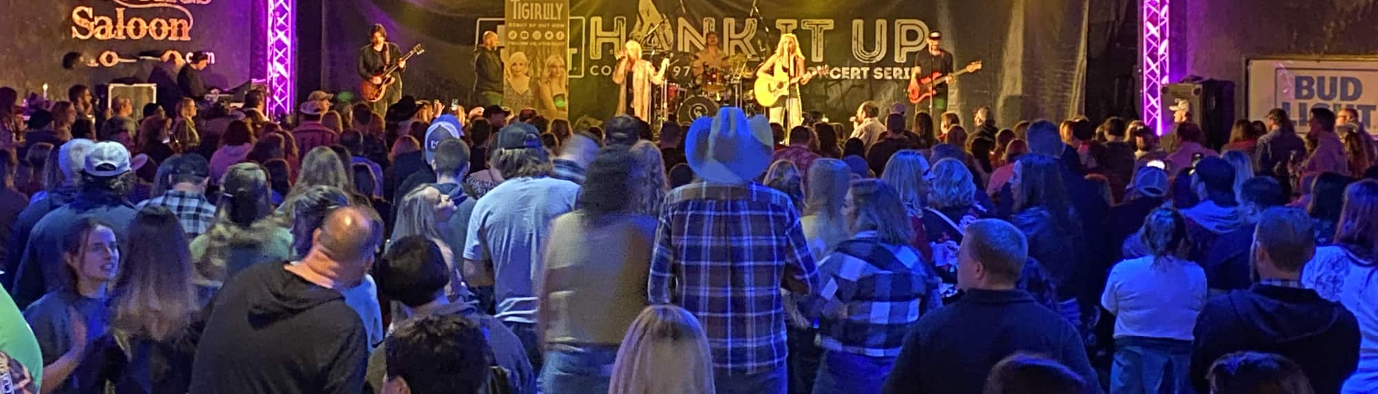 country concert with fans wearing cowboy hats Charlotte